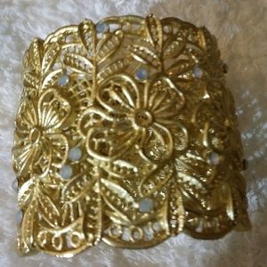 Gold tone wide hinged bracelet w/ stones